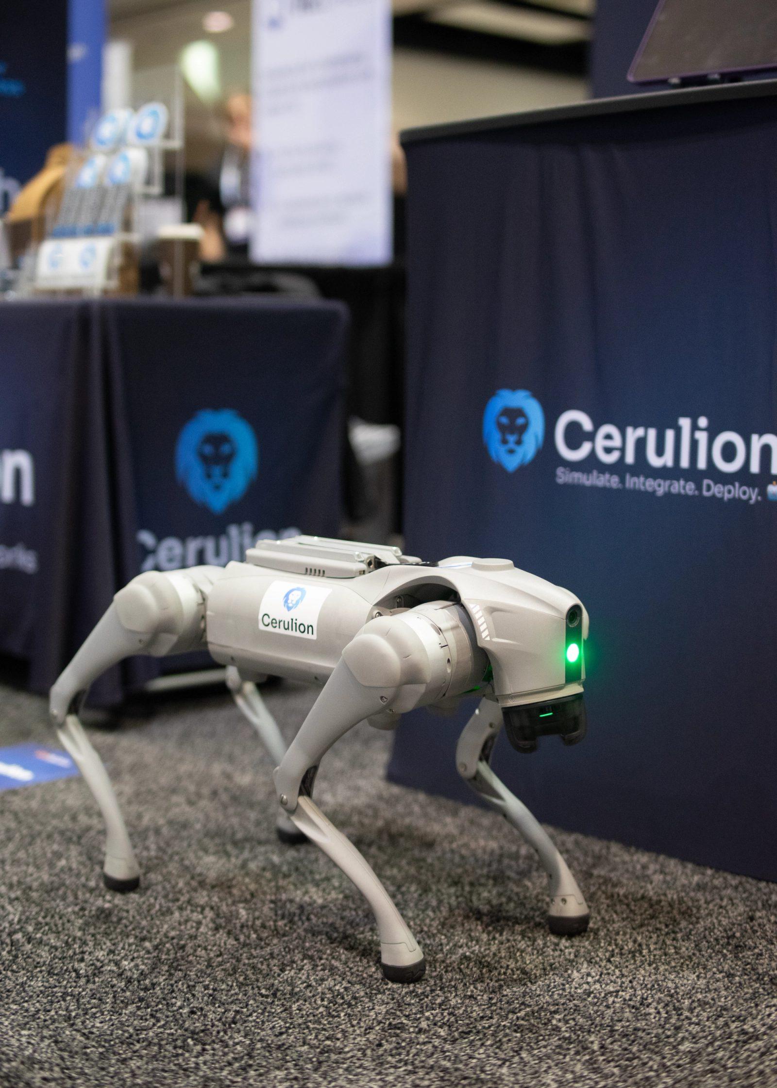 Lychee, a Unitree Go2 robot dog with a Cerulion sticker, stands in front of the Cerulion booth